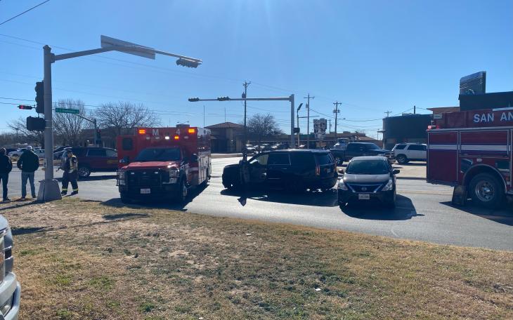 Emergency responders, including firefighters and paramedics, assess the scene of a collision involving a black Escalade at the intersection of South Chadbourne Street and East Avenue L in San Angelo.