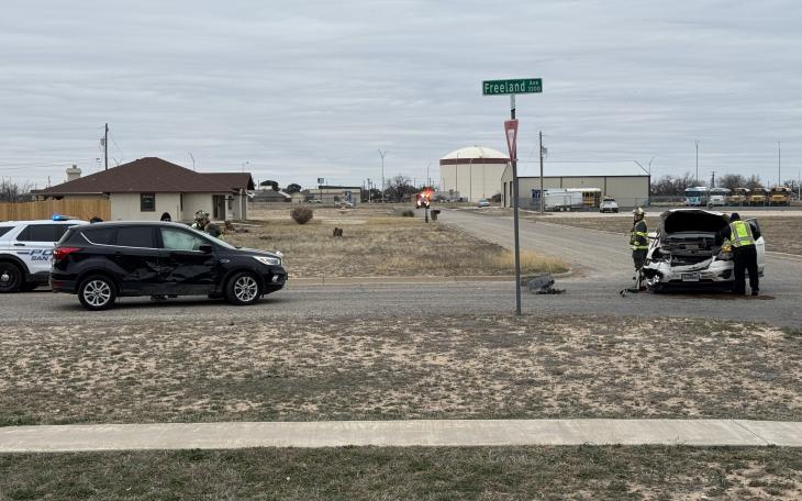 San Angelo Fire Department personnel work near a white Chevy Traverse, which sustained significant front-end damage in the crash at Freeland Avenue and Alexander Drive.