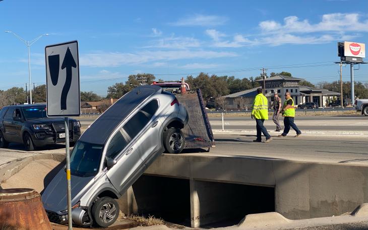 At one location, a vehicle ended up partially lodged in a drainage ditch along the Loop 306 frontage road.