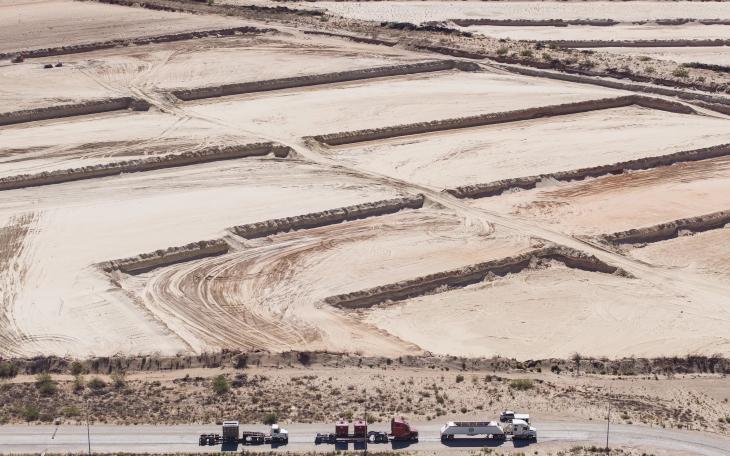 Truckers line up to receive a load of sand used in oil and gas fracking at the Capital Sand plant outside of Monahans in July 2024. Credit: Eli Hartman/The Texas Tribune