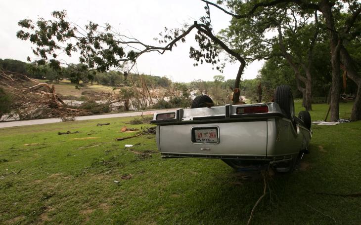 An overturned vehicle on the banks of the Blanco River on May 26, 2015, two days after catastrophic flooding in the Wimberley area.