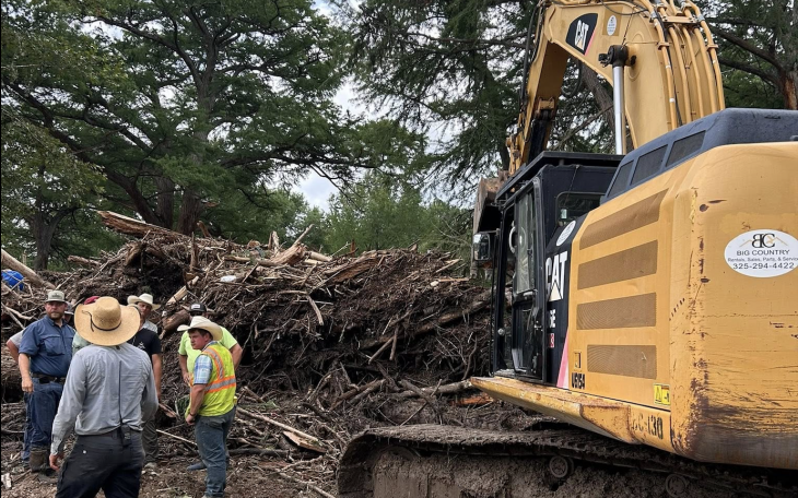 Workers sift through debris from the Guadalupe River flooding.