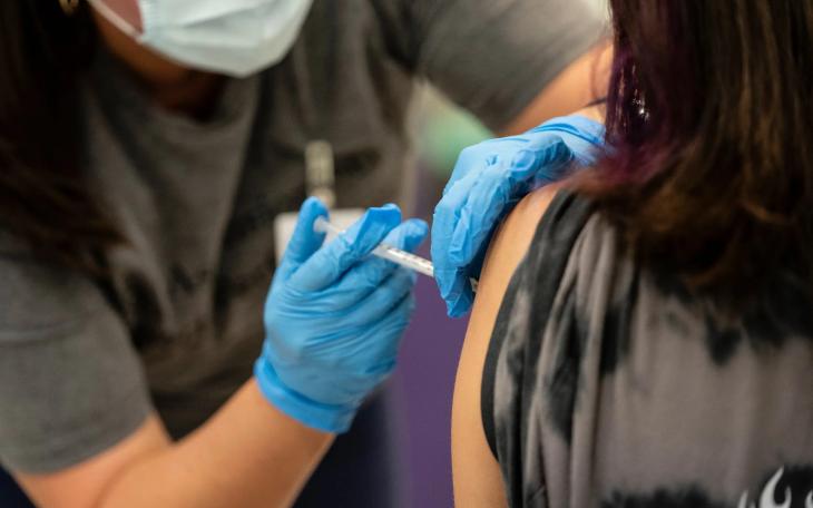 A nurse administers a dose of the COVID-19 vaccine at a clinic organized by the Travis County Mobile Vaccine Collaborative at Rodriguez Elementary School on July 28, 2021.