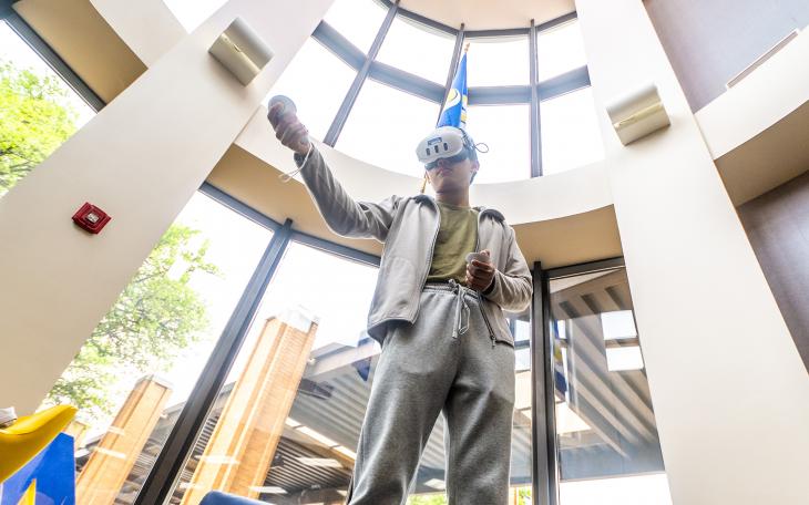 Student in AR goggles at ASU's 2025 Youth Cyber Expo