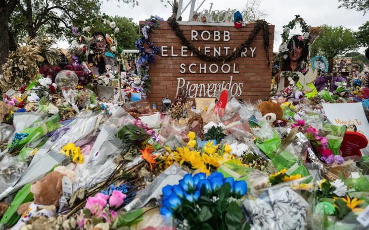 Hundreds of flowers, toys, and candles surround the crosses in memorial of the 21 victims of the Robb Elementary school shooting at Robb Elementary in 2022. Credit: