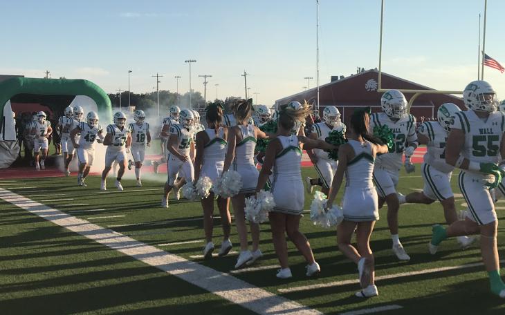 The Wall Hawks run onto the field before their football game with Jim Ned in Tuscola on Friday, Sept. 12, 2025.