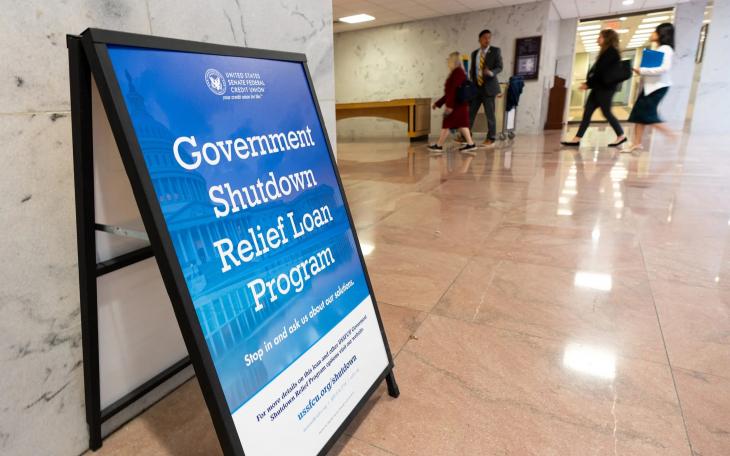 A sign advertises a government shutdown relief loan program outside the United States Senate Federal Credit Union branch office in the Hart Senate Office Building in Washington on Tuesday, Sept. 30, 2025.