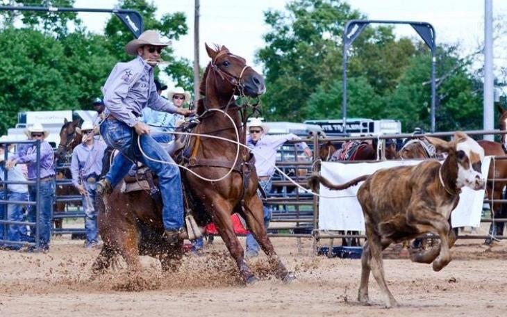 Caleb Smidt is showing roping a calf at an event in Bellville in 2014.