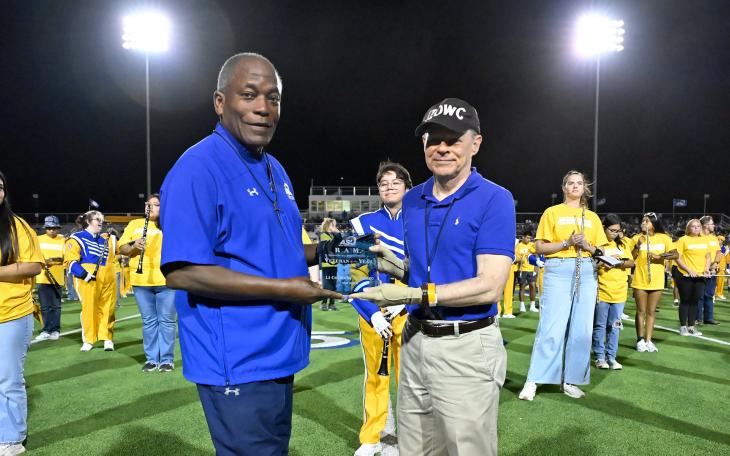 (L-R) ASU President Ronnie Hawkins presented Ricky Hudec the 2025 ASU Veteran of the Year plaque during ASU's Military Appreciation Day football game Nov. 8