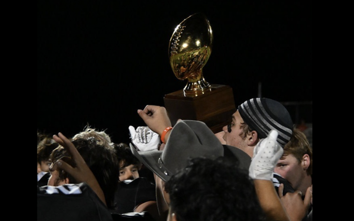 The Water Valley Wildcats hoist a bidistrict playoff trophy after their 62-14 win over Hermleigh on Thursday, Nov. 13, 2025.