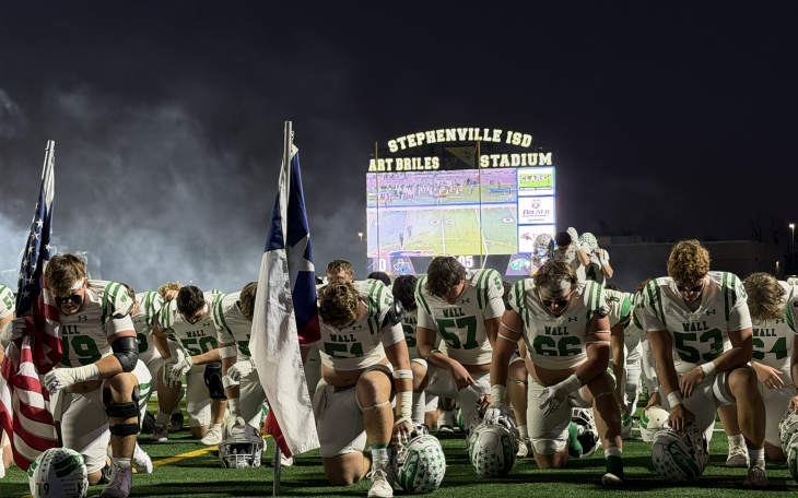 The Wall Hawks take a moment to pray before their state semifinal game against Gunter on Friday, Dec. 12, 2025, in Stephenville.
