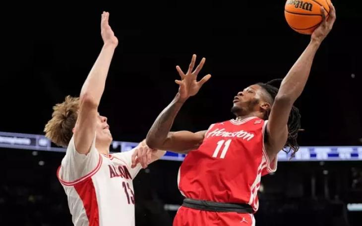 Houston's Joseph Tugler shoots over an Arizona defender during the SEC Tournament Final on March 14, 2026.