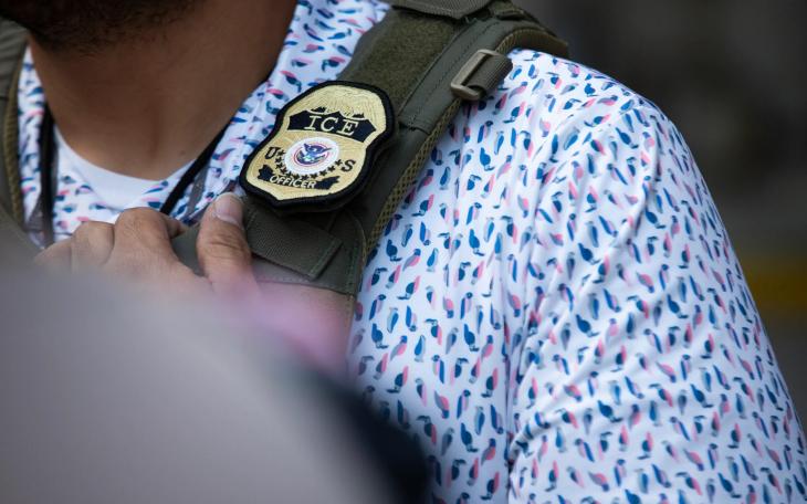 A U.S. Immigration and Customs Enforcement agent’s badge in front of the J.J. Pickle Federal Building in Austin on April 1, 2025.