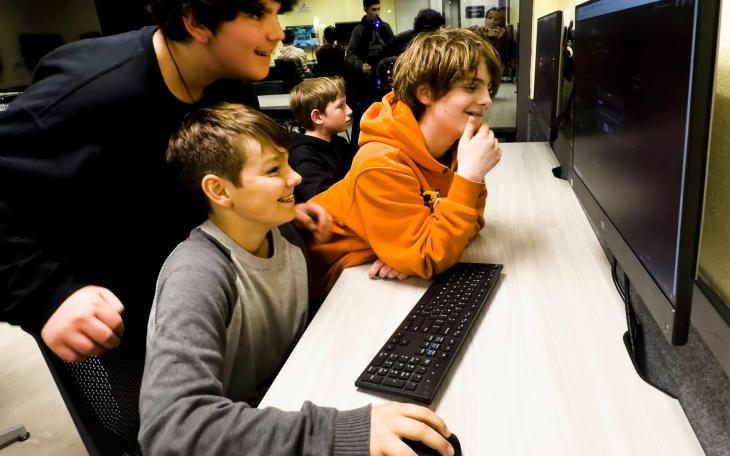 Arthur Grenner, 13, left, Chad Darden, 12, and Steve Yanes, 13, at right, engage with the video game platform Roblox during the Thousand Oaks Teen Center's reopening celebration in Thousand Oaks, California on March 10, 2023.
