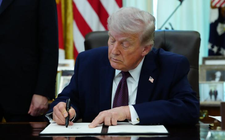 President Donald Trump signs an executive order on election integrity in the Oval Office of the White House in Washington on March 31, 2026.
