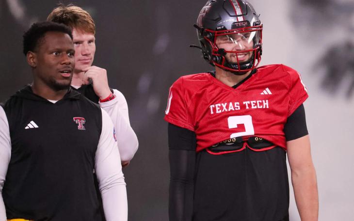 Texas Tech players Brendan Sorbsy (right) and Willi Hammond (back) and assistant quarterbacks coach Lindsey Scott look on during spring football practice at the at the Womble Football Center in Lubbock on April 7, 2026.