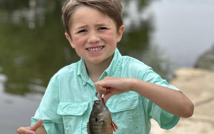 Kid caught a fish at fishing derby