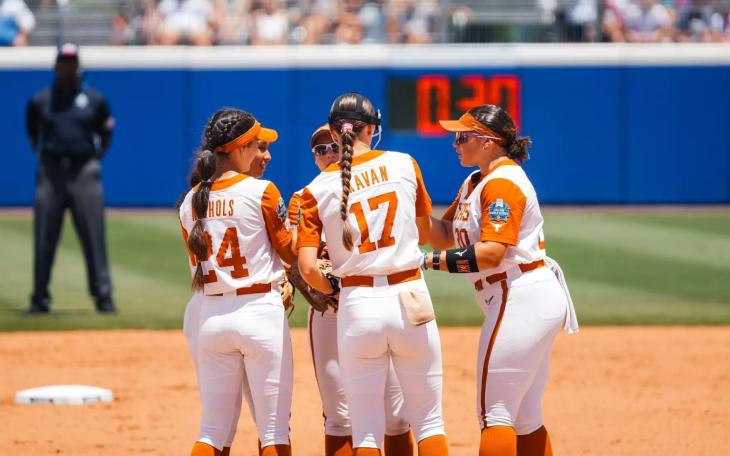 The Texas Longhorns softball team meets in the infield during the 2026 Women's College World Series.