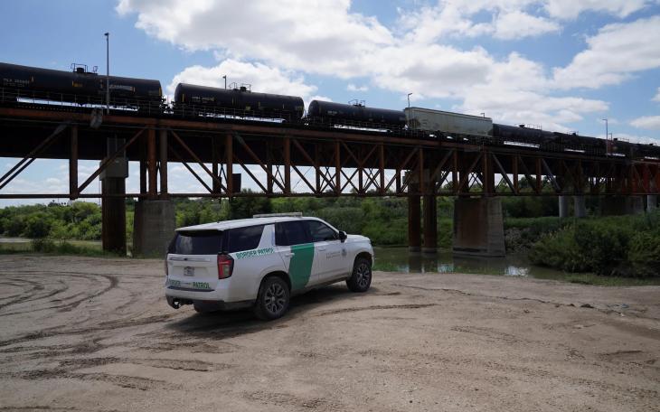 Border Patrol agents monitor the Rio Grande on May 11, 2026, after six bodies were found in a train boxcar in Laredo.
