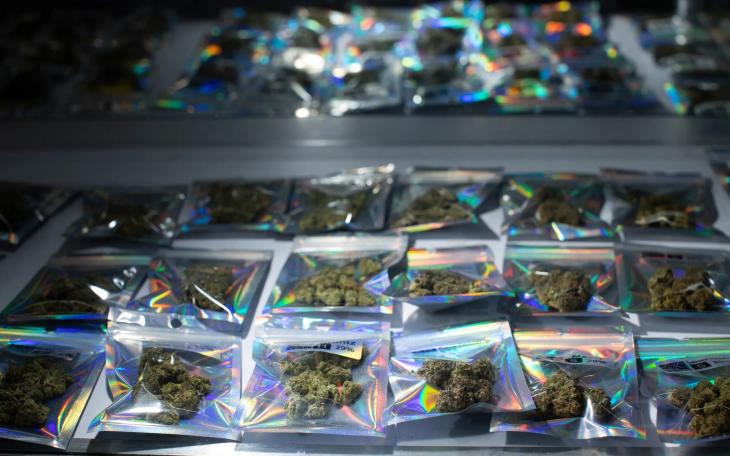 Individual packages of THC-A flower are seen in a display case at a smoke shop in Austin on May 13, 2026.