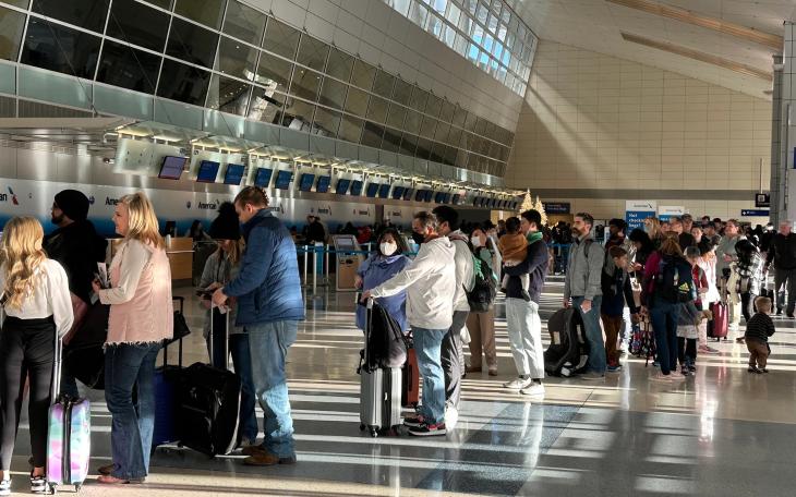 American Airlines passengers wait in a TSA security line at Dallas Fort Worth International Airport, Dec. 18, 2022.
