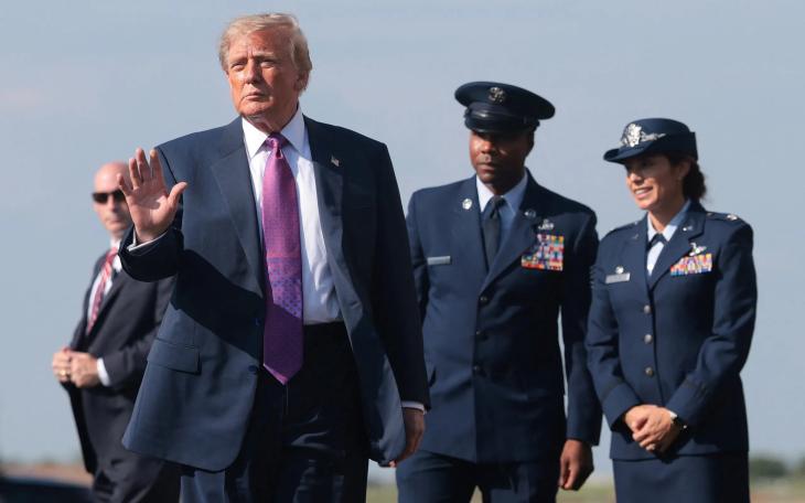 U.S. President Donald Trump waves to supporters after disembarking Air Force One at Ellington Field Joint Reserve Base in Houston on Aug. 27, 2026.