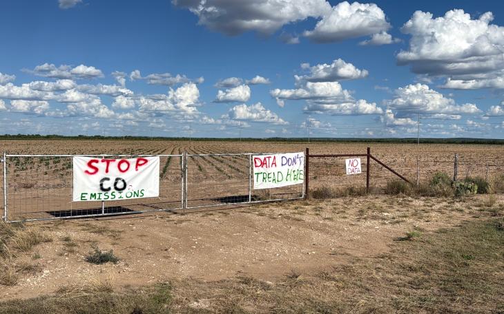Protest signs near the proposed Beacon Data Centers project site in southwest Tom Green County