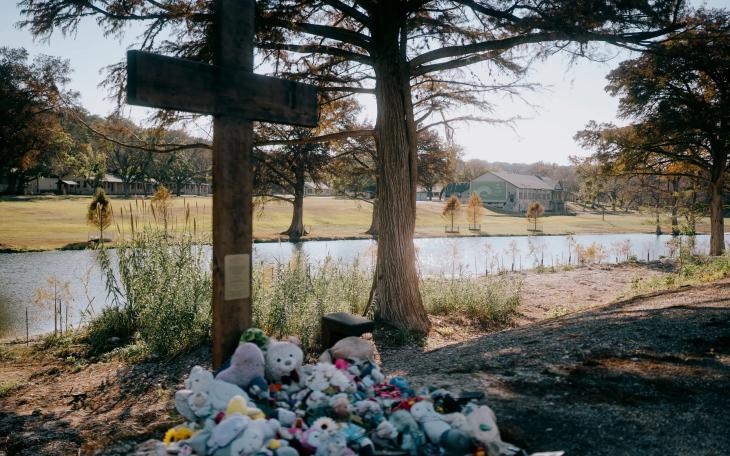 A cross honoring the victims of the July 4, 2025, flood stands in front of Camp Mystic across the Guadalupe River on Nov. 21, 2025.