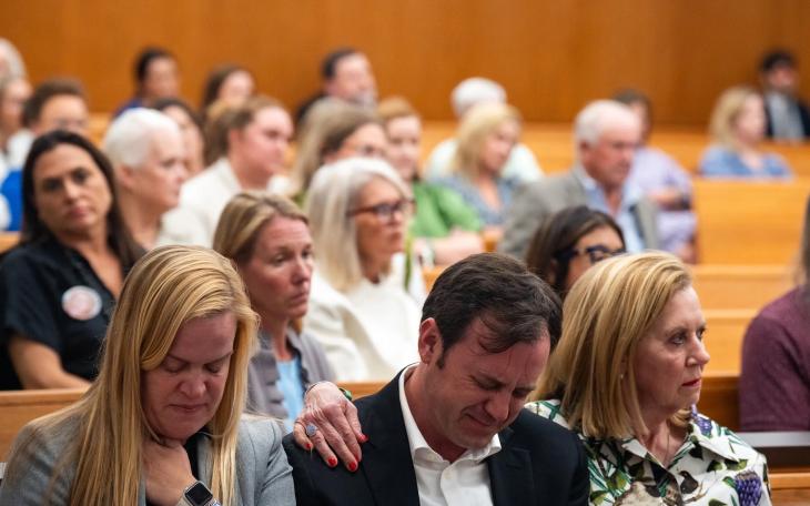 Edward Eastland breaks down in tears as he’s comforted by Tweedy Eastland, right, and Mary Liz Eastland, left, during a hearing on a lawsuit against Camp Mystic in an Austin courtroom on April 14, 2026.