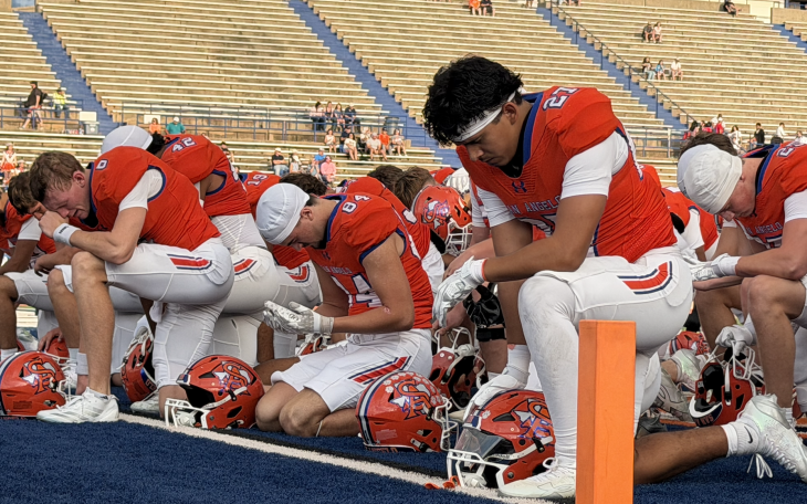 The San Angelo Central Bobcats pray before their game against the Abilene Cooper Cougars
