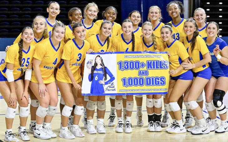 2026 Volleyball Team celebrating Madi Parrish 1,000 digs