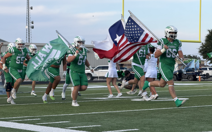 The Wall Hawks run onto the field before their game against Midland Greenwood on Friday, Sept. 25, 2026.
