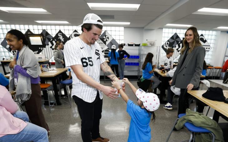 Chicago White Sox pitcher Davis Martin interacts with a young fan during the 2026 season.