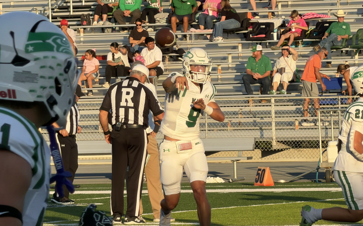 Wall quarterback Gunner King fires a pass in warmups before the Hawks' game against Llano on Friday, Oct. 9, 2026.