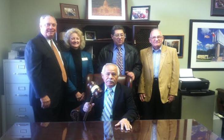 Gutierrez sits in the big chair with his gavel, surrounded by supporters (LIVE! photo by Cheyenne Benson)