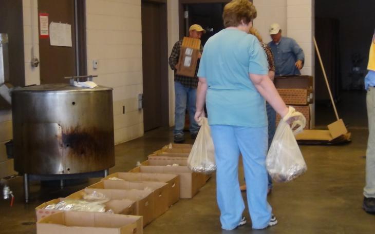 A Lions Club Member helps put briskets in bags (LIVE! photo by Cheyenne Benson)