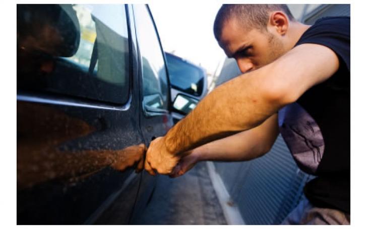 A thief prepares to break into a car (photo courtesy of naylornetwork.com)