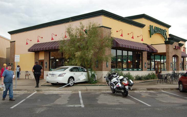 A car sits nestled up to the McCalister's facade, following an accidental crash. (LIVE! Photo by Chelsea Schmid)