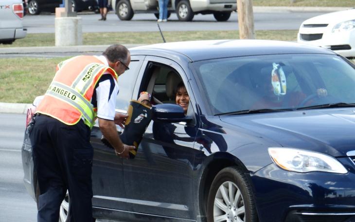 Battalion Chief Royce Owen collects a donation on Bryant Boulevard in San Angelo on Wednesday. (LIVE! Photo/Matt McDaniel)