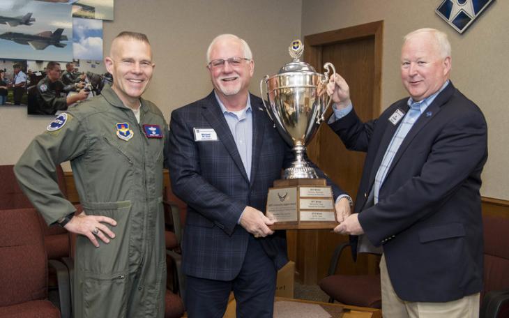 Mike Boyd, center, holding the 2019 award to San Angelo of the Altus Trophy for community support of an Air Force base.