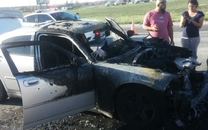 A Dodge Charger caught fire early Sunday evening on the frontage road to the Houston Harte Expressway on March 29, 2015. (LIVE! Photo/Amanda Henson)