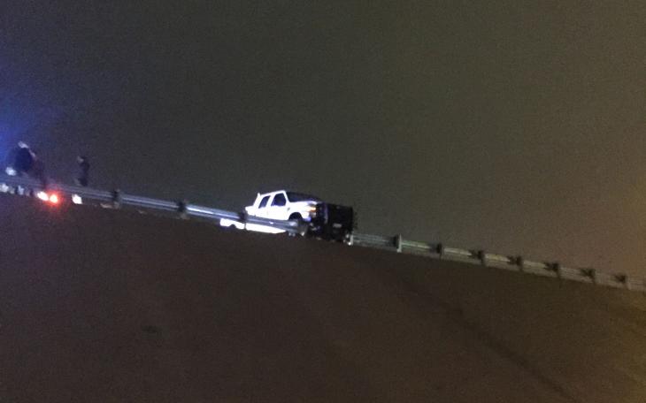 A pickup truck that ran off Loop 306 near College Hills hangs in balance. (LIVE! Photo/Megan Holmquest)