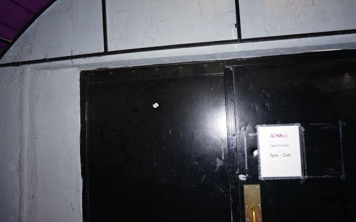 Bullet hole in the door of the main entrance to Desiree's from Monday night's gun fire on Mar. 10, 2014. (LIVE! Photo/John Basquez)