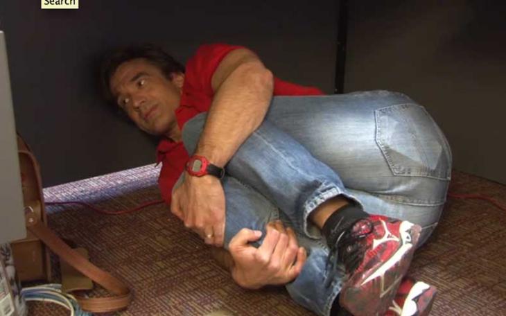 City of San Angelo Public Information Officer Anthony Wilson crawls under his desk in fear of San Angelo LIVE! (Video screenshot/Anthony Wilson)
