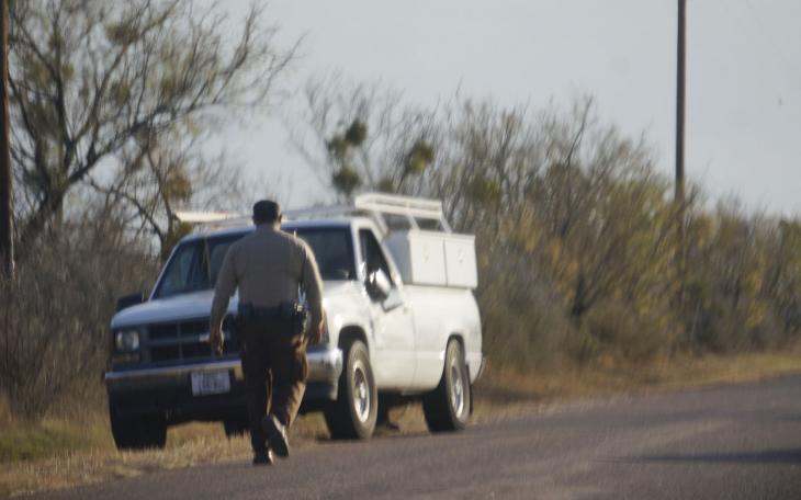 TGCSO deputy approaches the suspect's abandoned vehicle on E. Red Creek Road. (LIVE! Photo/John Basquez)