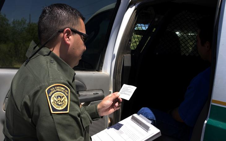 A CBP officer reads the Miranda Rights to a suspect apprehended for drugs. (Contributed/CBP)