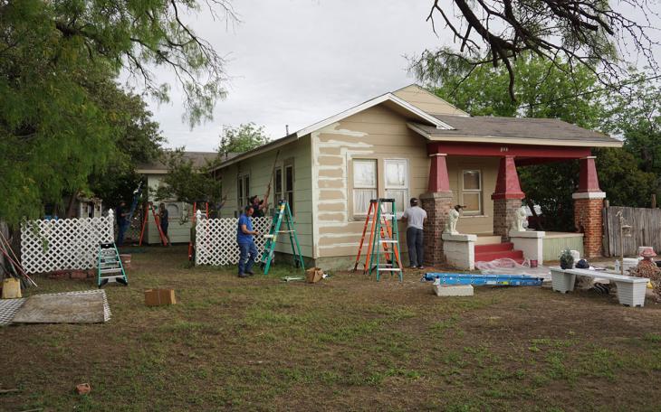 City employees paint houses on E. Harris St. as part of the annual blitz. (LIVE! Photo/John Basquez)