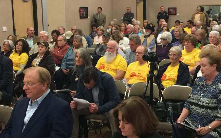 Lee Pfluger (left, blue suit). Behind him are protesters against his plan to build a sand depot on Hill St. (LIVE! Photo/Joe Hyde)