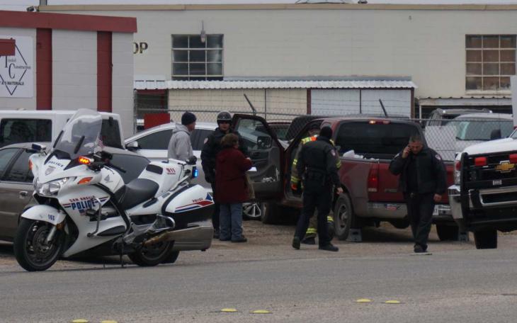 The driver of the red pickup suffered a seizure and crashed into a parked car and building on Austin St. (LIVE! Photo/John Basquez)