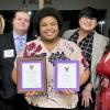 Daysha Johnson (center) with Delta Sigma Pi officials and her awards: